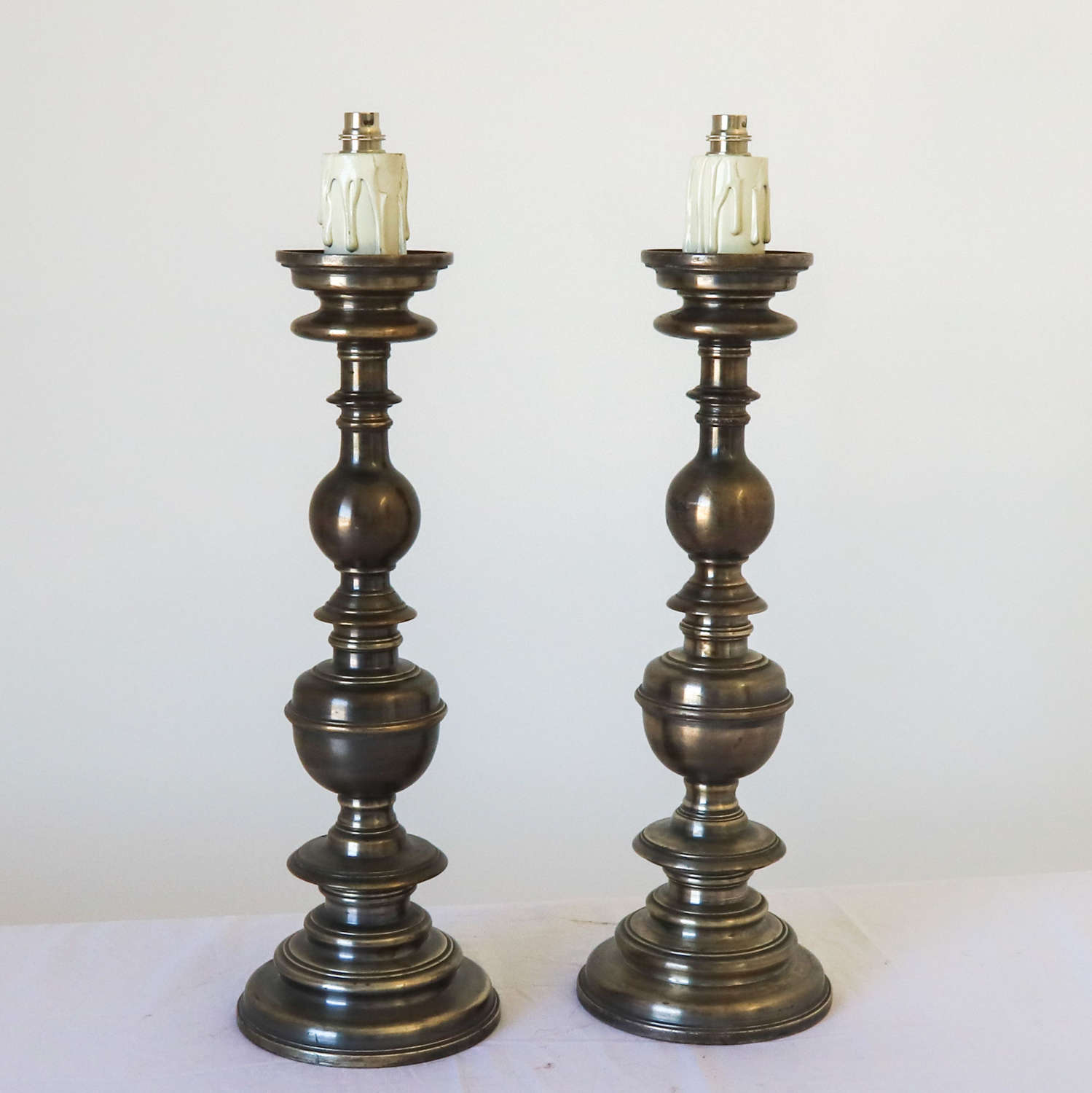 Pair of silvered brass candlesticks later converted to lamps
