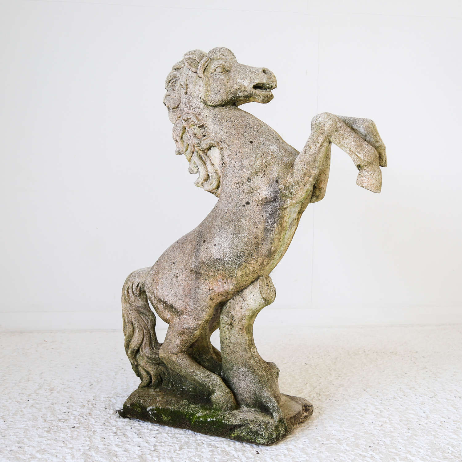 Early 20th century English stone prancing horse with weathered patina